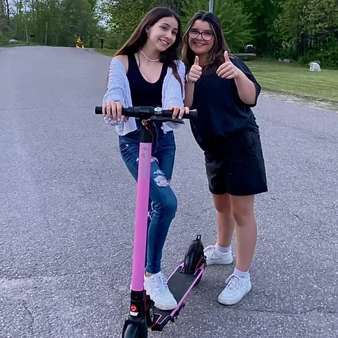 two kids using electric scooter